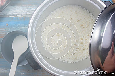 Chef open lip of electric rice cooker Stock Photo