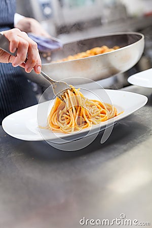 Chef plating up seafood pasta Stock Photo