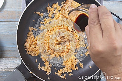 Chef pouring soy sauce to pan for cook fried rice Stock Photo