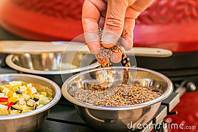 Chef prepares ingredients for bulgur on the grill Stock Photo