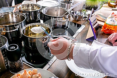 Chef prepares ingredients for tuna tartare. Master class in the kitchen. The process of cooking. Step by step. Tutorial. Close-up Stock Photo