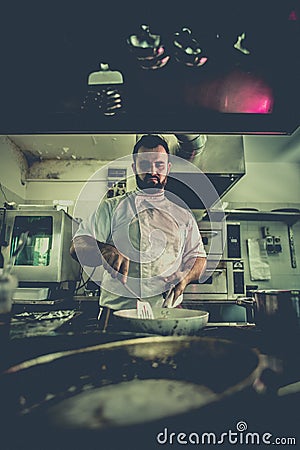 Chef preparing beef fillet steak in a frying pan Grunge style Stock Photo