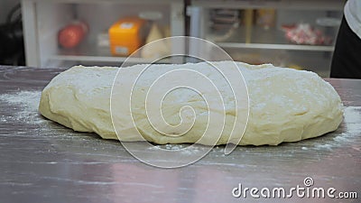 The chef is preparing the dough, the cook is working with the dough in the kitchen, the chefs are sculpting the dough Stock Photo