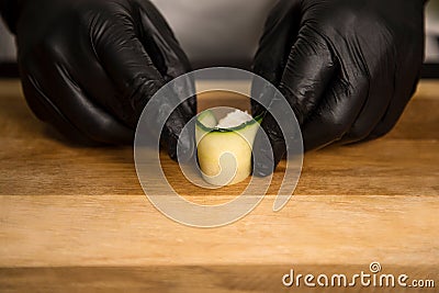 Japanese Gunkan Sake Green. Rice wrapped in cucumber. Close up of sushi cooking process Stock Photo