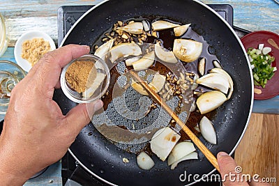 Chef put dashi powder for cooking beef with rice Stock Photo