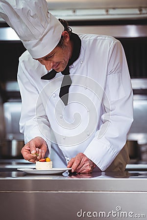 Chef putting finishing touch on dessert Stock Photo
