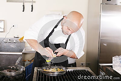 Chef putting grated parmesan to an italian pasta Stock Photo