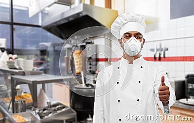 Chef in respirator showing thumbs up at kitchen Stock Photo