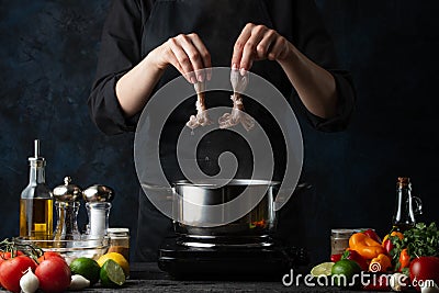 The chef`s hands puts fresh octopuses into the pot with boiling water for preparing traditional asian dish for dinner. Backstage Stock Photo