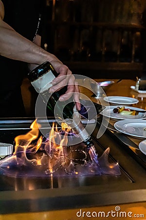 Chef cooking in Japanese teppanyaki restaurant Stock Photo