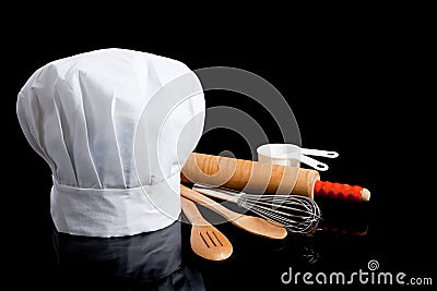 A Chef's toque with cooking utensils Stock Photo