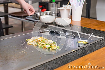 Chef seasoning freshly cooked Asian stir fry Stock Photo