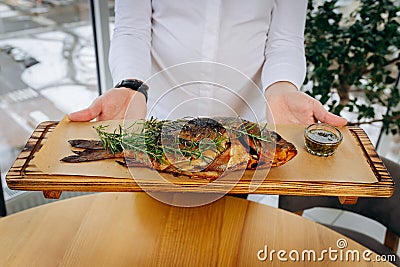 Chef serving freshly delicious river carp fish in the restaurant hall Stock Photo
