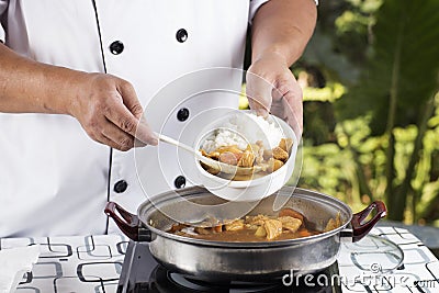 Chef shovel Japanese pork curry with steam rice Stock Photo
