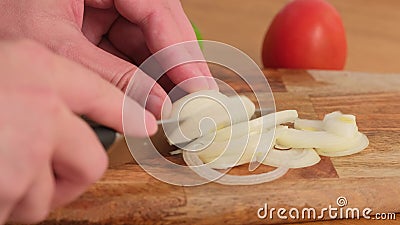 Chef slices onion. knife, cutting onion. Healthy food. Close-up. Stock Photo