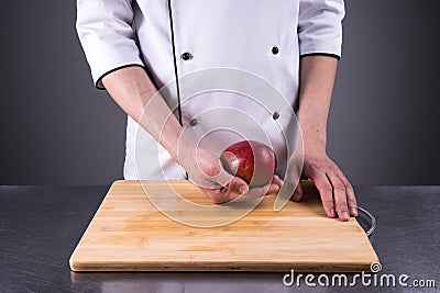 Chef slices and peels ripe mango in the restaurant kitchen9 Stock Photo