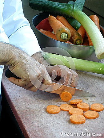 Chef is slicing carrots Stock Photo