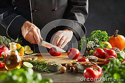 Chef slicing salad ingredients in a restaurant Stock Photo