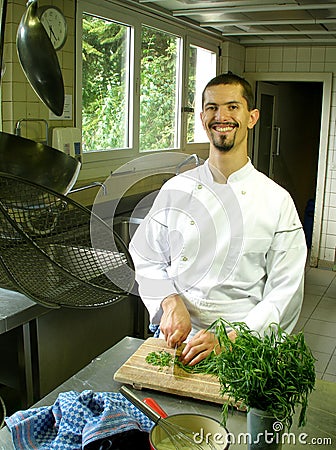 Chef slicing tarragon Stock Photo