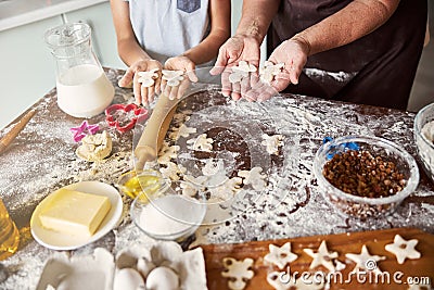 Chef and sous-chef making gingerbread men out of dough Stock Photo