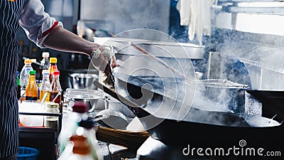 Chef stir fry in wok Stock Photo