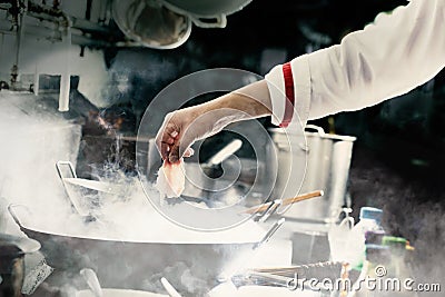 Chef stir fry in wok Stock Photo