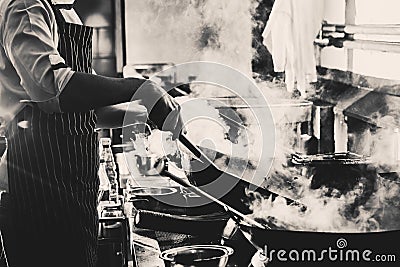 Chef stir fry in wok Stock Photo