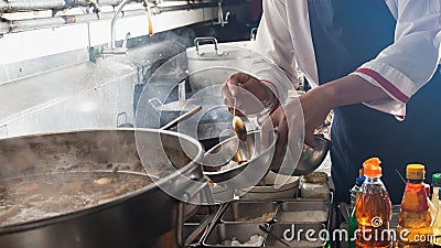 Chef stir fry in wok Stock Photo