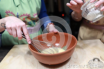 Chef stirring eggs with flour to make dough Stock Photo