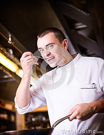 Chef is tasting the cooked dish Stock Photo