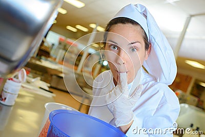 Chef tasting food from gloved finger Stock Photo