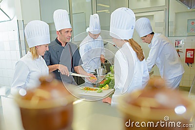 Chef teaching students on cookery course Stock Photo