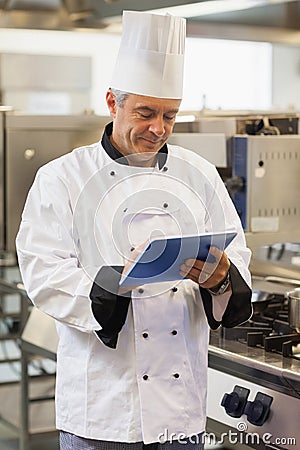 Chef using his digital tablet Stock Photo