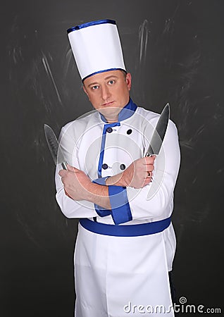 Chef wearing workwear and holding a knife Stock Photo