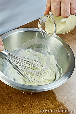 Chef whisk mayonnaise in a bowl in hand a series of full cooking food recipes Stock Photo