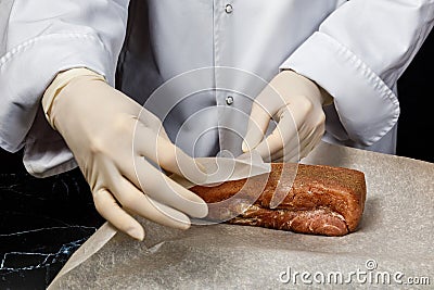 The chef wraps the meat for drying Stock Photo