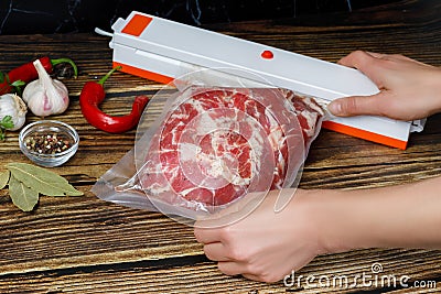 The chef wraps the meat in the package Stock Photo