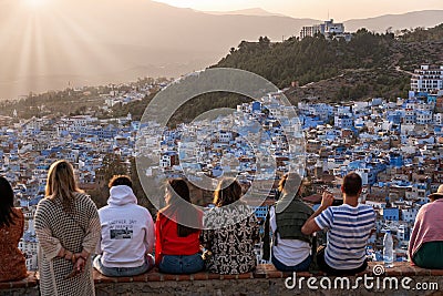 CHEFCHAOUEN, MOROCCO - MAY 05, 2023 - Tourists enjoying the sunset over famous blue colored city Chefchaouen in Morocco Editorial Stock Photo