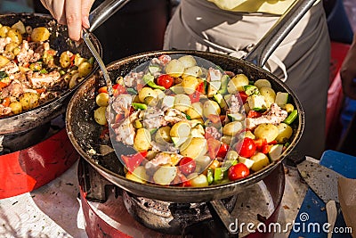 Cheff cooking traditional Mediterranean octopus on street stall. Stock Photo