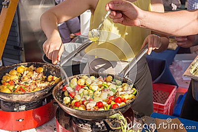 Cheff cooking traditional Mediterranean octopus on street stall. Stock Photo