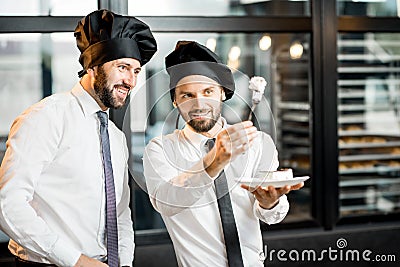 Chefs with cake in the office Stock Photo