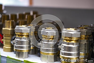 Chelyabinsk Region, Russia - JUNE 2019. Plumbing sales. Rack with goods. Some metal valves and fittings on a shelf in a workshop Editorial Stock Photo