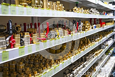 Chelyabinsk Region, Russia - JUNE 2019. Plumbing sales. Rack with goods. Some metal valves and fittings on a shelf in a workshop Editorial Stock Photo