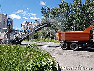 Chelyabinsk, Russia, may 29, 2020. Road repairs, cars clean the road from old asphalt Editorial Stock Photo