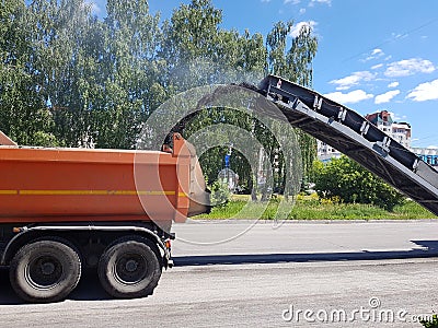 Chelyabinsk, Russia, may 29, 2020. Road repairs, cars clean the road from old asphalt Editorial Stock Photo