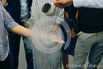 Chemical event at the birthday party: children's hands touch the smoke from liquid nitrogen Editorial Stock Photo