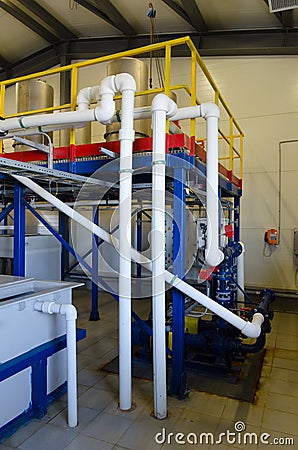 Chemical factory. Cables pumps and piping. Stock Photo