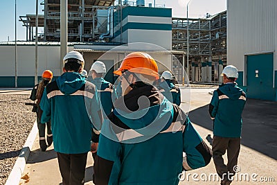 Chemical factory workers in working clothes walks to their workplaces Editorial Stock Photo