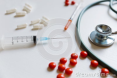 Chemical medicine pills, stethoscope and syringe on white background Stock Photo