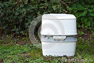 Chemical portable toilet. Single portable toilet standing on a green meadow Stock Photo
